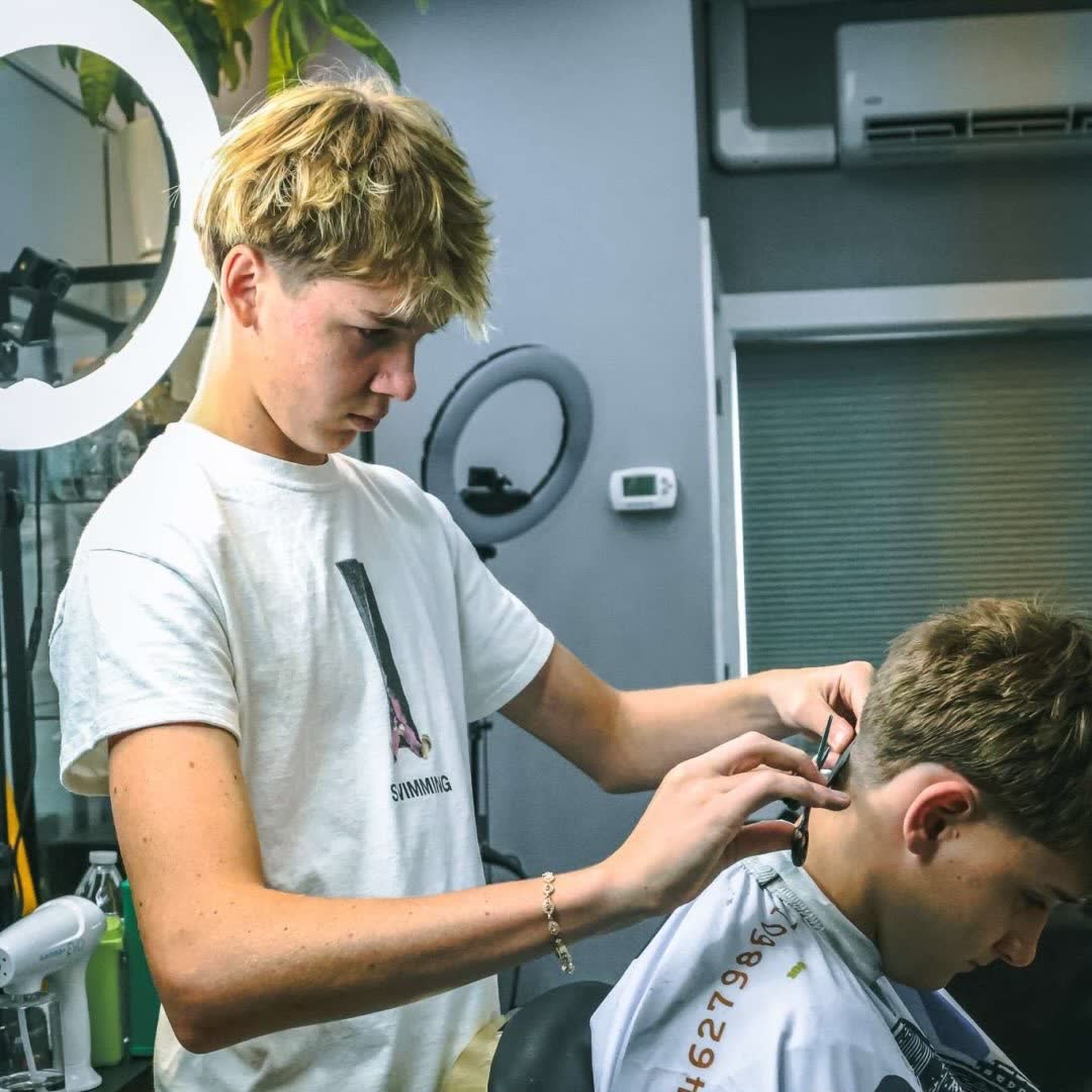 Wins detailing a client's taper with clippers